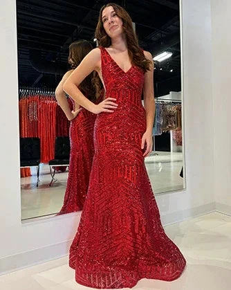 Woman in a sparkly red evening gown posing in a boutique, ZAPDRESS formal dress fashion