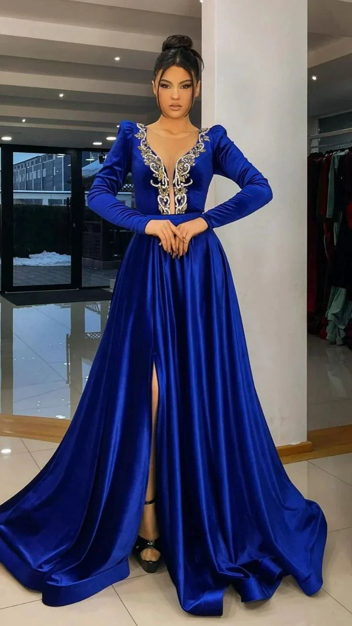 Woman in a royal blue satin evening gown with gold embroidery and front slit at ZAPDRESS store