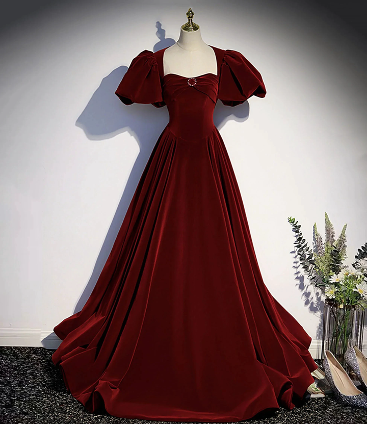 Elegant burgundy velvet ball gown with puff sleeves on mannequin, Zapdress fashion display