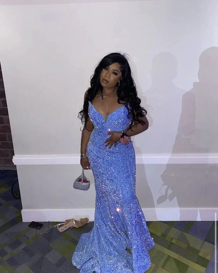 Woman in sparkling blue evening gown posing at formal event, stylish ZAPDRESS fashion