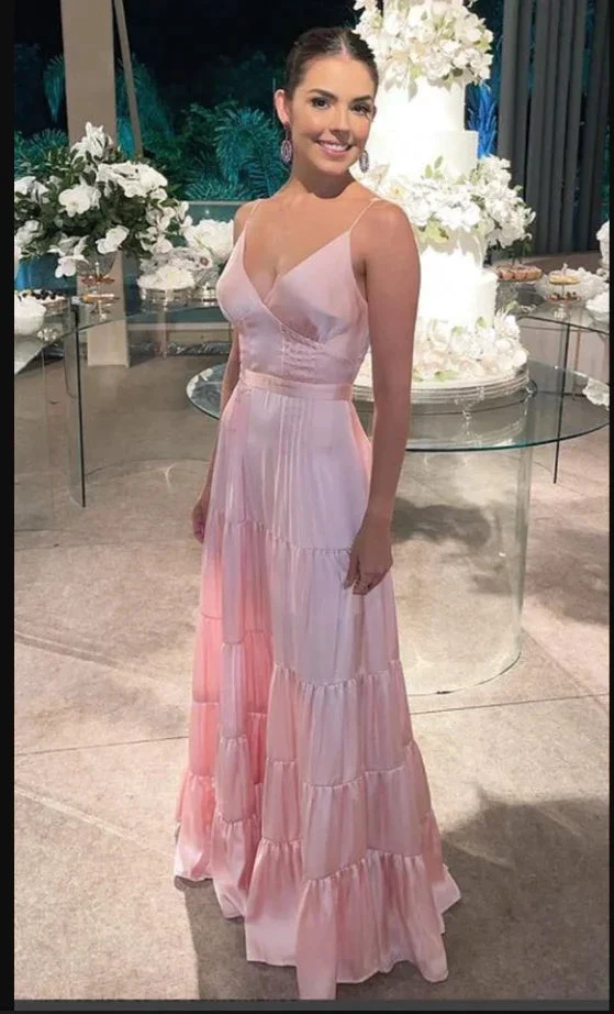 Woman in a light pink tiered dress at an elegant event with floral decor and cake, ZAPDRESS