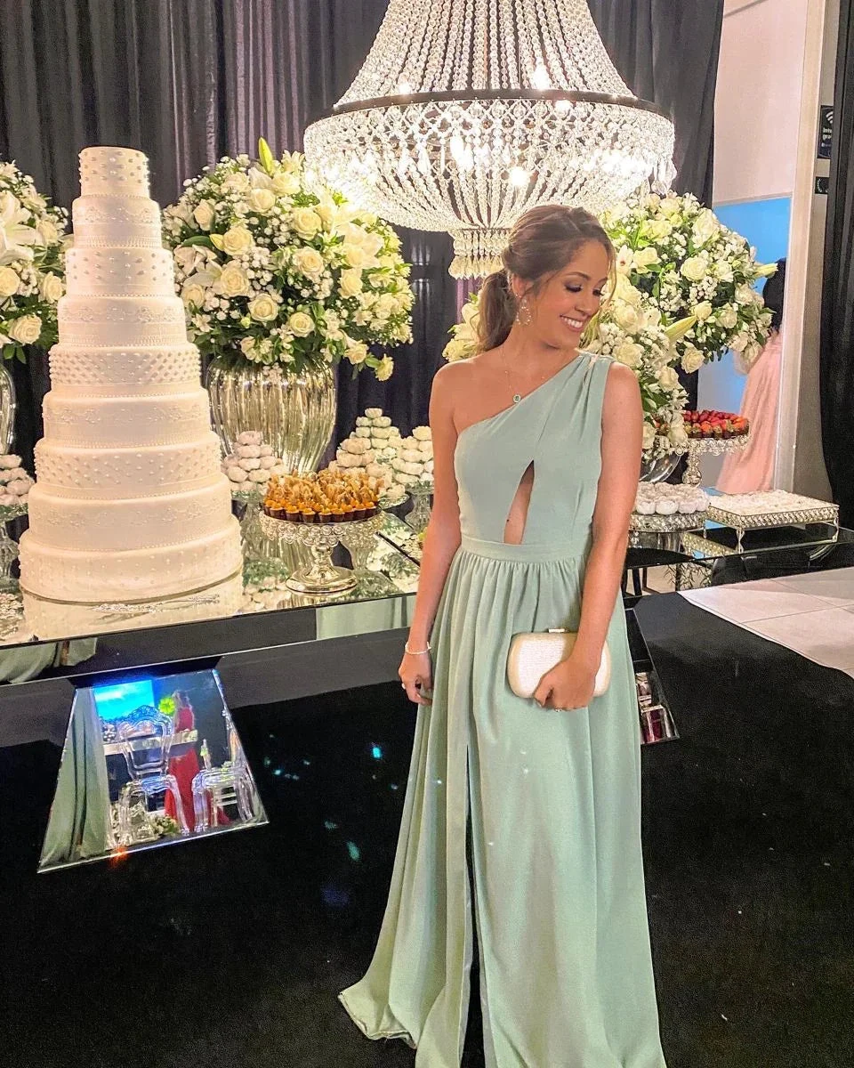 Woman in elegant mint green dress at formal event with large chandelier, floral arrangements, and tiered white cake, ZAPDRESS fashion