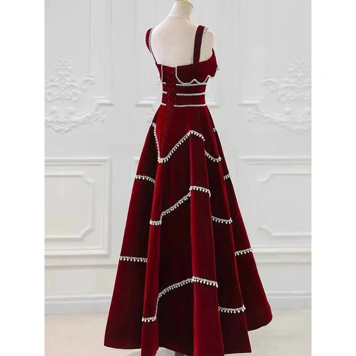 Elegant red velvet evening dress with crystal trim, displayed on mannequin, ZAPDRESS