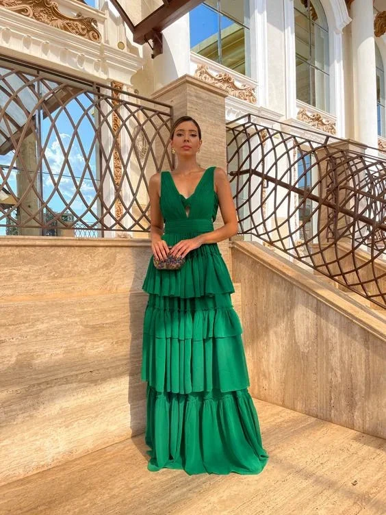 Woman in elegant green tiered maxi dress posing on marble stairs, ZAPDRESS fashion style
