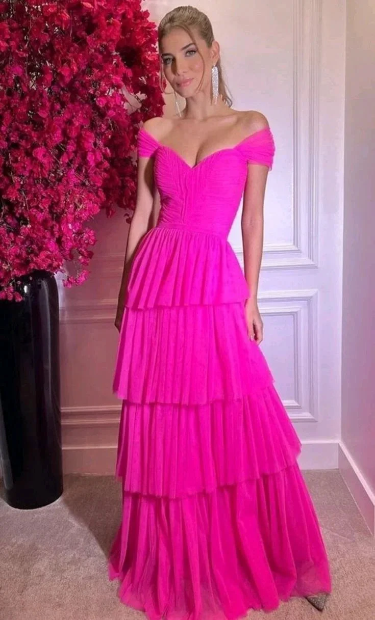 Woman wearing bright pink off-shoulder tiered evening dress by ZAPDRESS