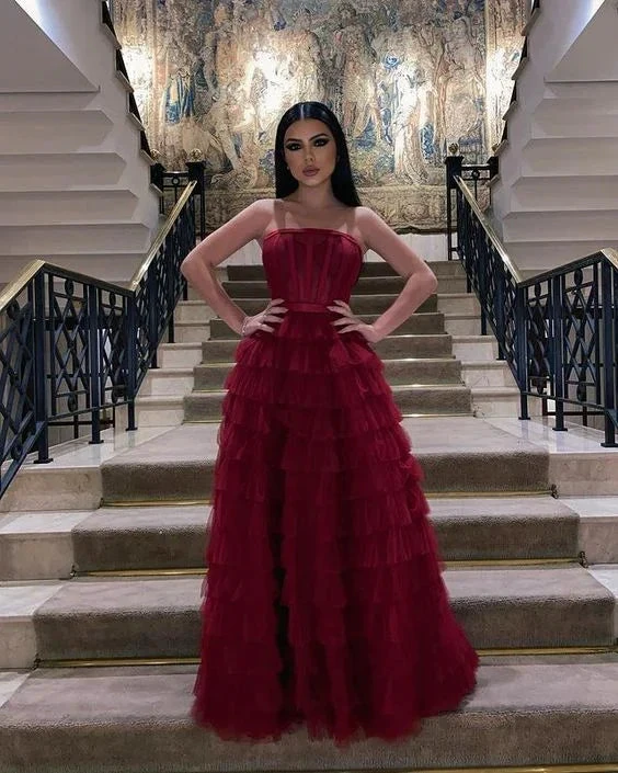 Elegant woman in a ruffled red evening gown on a grand staircase, ZAPDRESS fashion