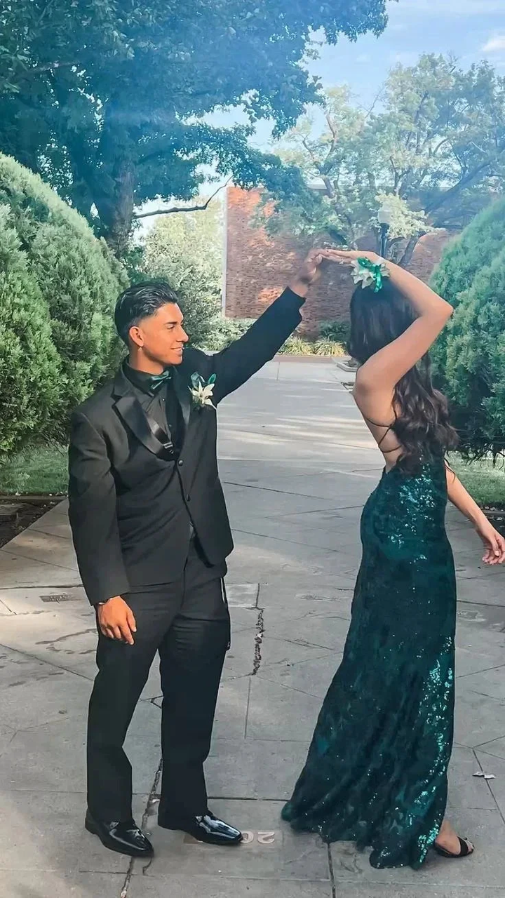 Couple dancing outdoors, man in black suit and woman in green sequin dress, ZAPDRESS event style