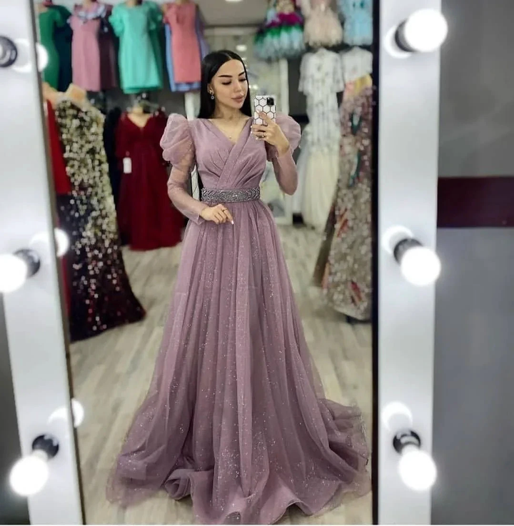 Woman in mirror selfie wearing a sparkly mauve evening gown at ZAPDRESS boutique