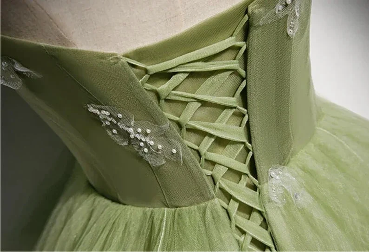 Close-up of green lace-up dress bodice with floral embroidery, ZAPDRESS fashion