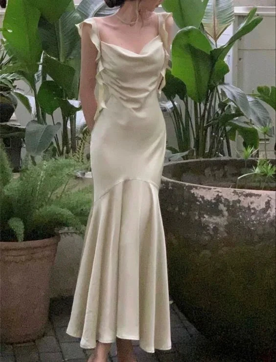 Woman in pale yellow satin evening dress with ruffle sleeves, garden background, ZAPDRESS style