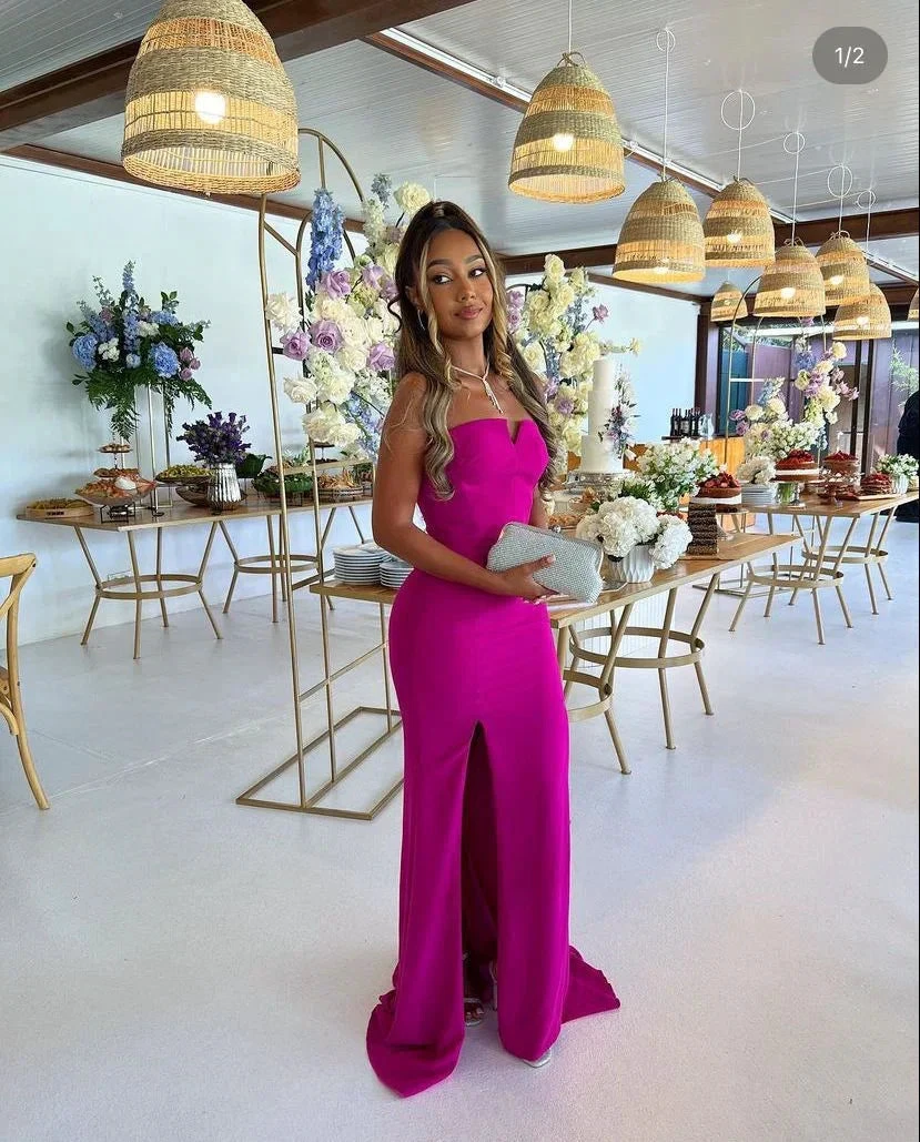 Woman in elegant magenta gown at floral event, ZAPDRESS fashion, modern party setting