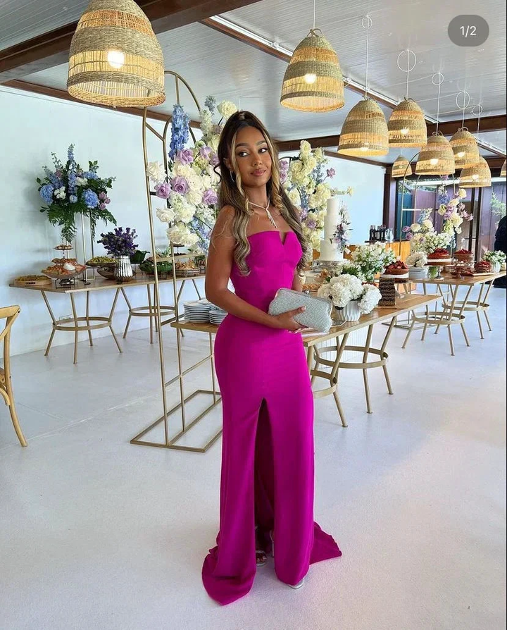 Woman in elegant magenta gown at floral event, ZAPDRESS fashion, modern party setting
