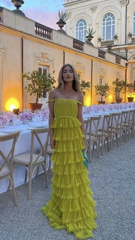 Woman in ruffled yellow evening dress at elegant outdoor dinner party, ZAPDRESS fashion