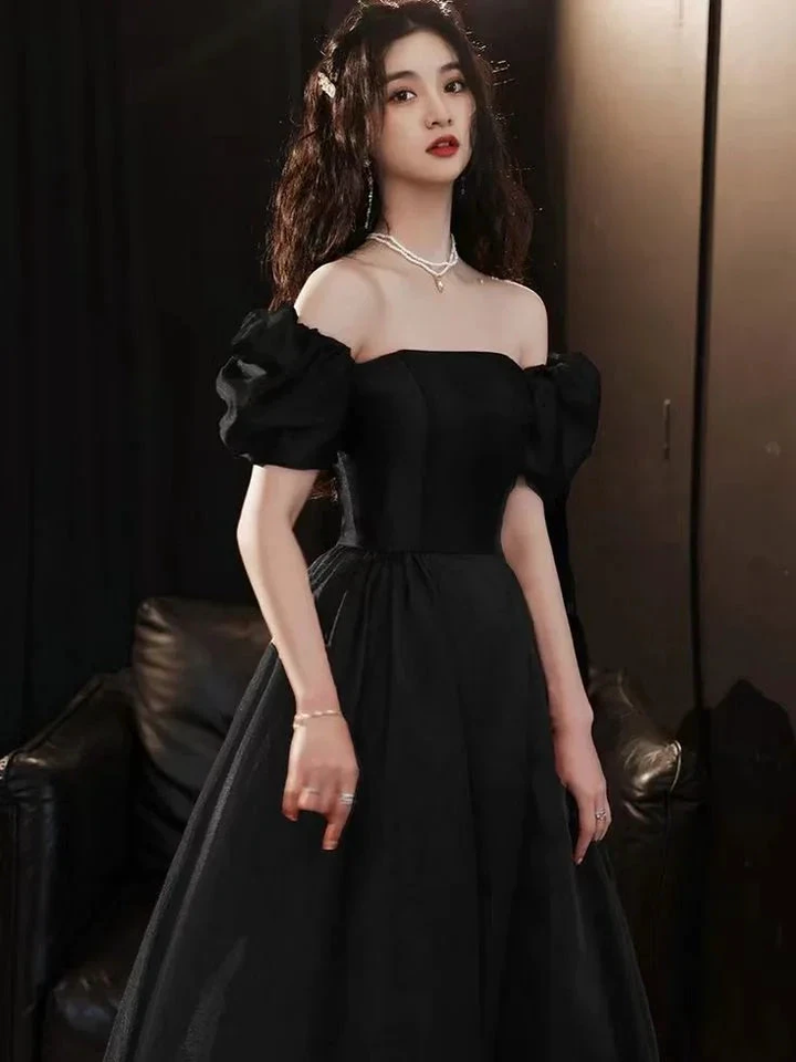 Elegant woman in off-shoulder black evening gown with puff sleeves, ZAPDRESS fashion