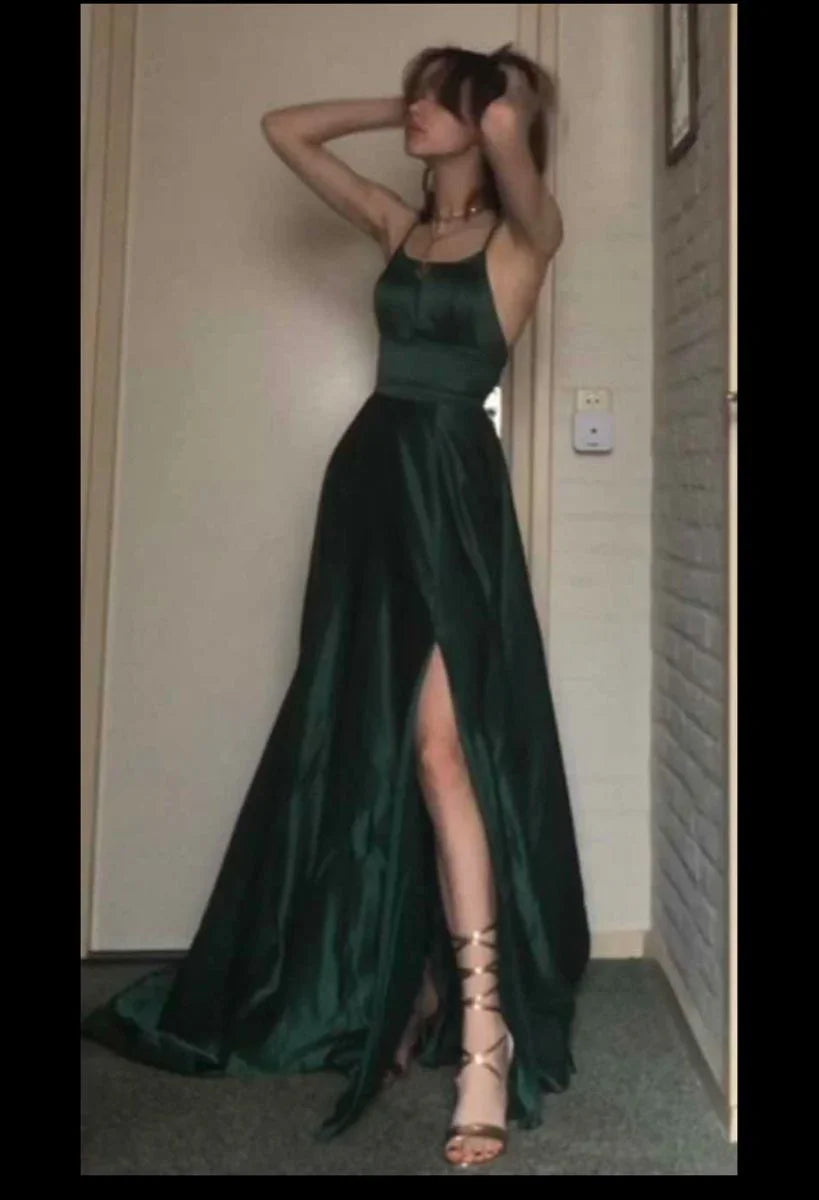 Woman modeling a dark green satin evening dress with spaghetti straps and high slit, ZAPDRESS