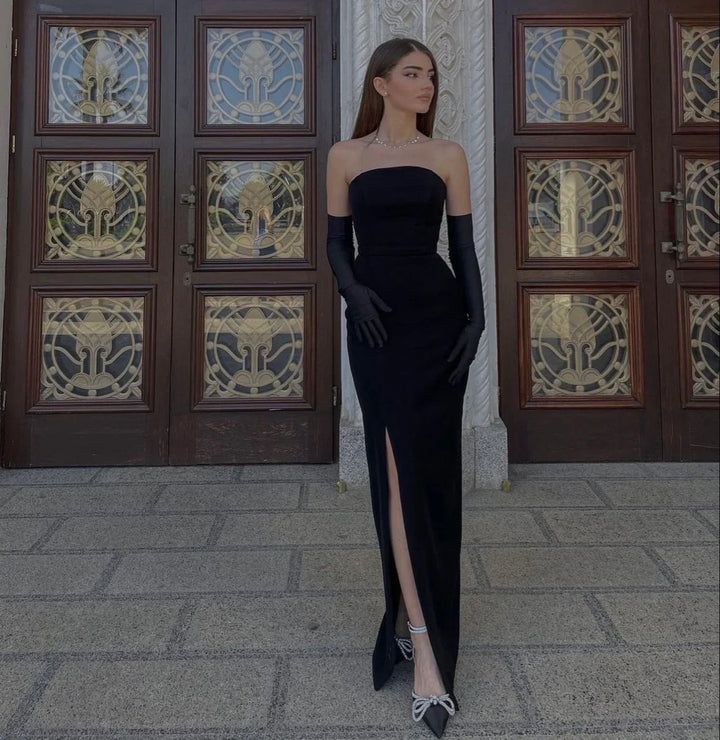 Woman in elegant black strapless evening gown with long gloves, posing by ornate doors, ZAPDRESS