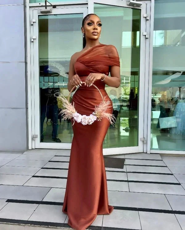 Woman in elegant rust-orange satin evening gown holding floral hoop bag, ZAPDRESS style