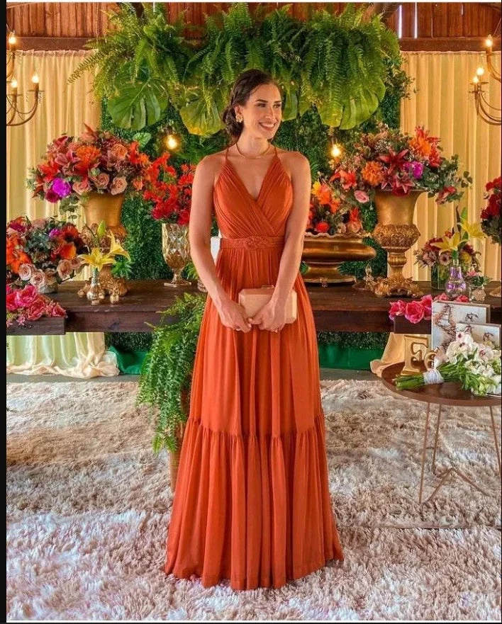 Woman in elegant rust orange sleeveless dress at floral event decor, ZAPDRESS fashion style