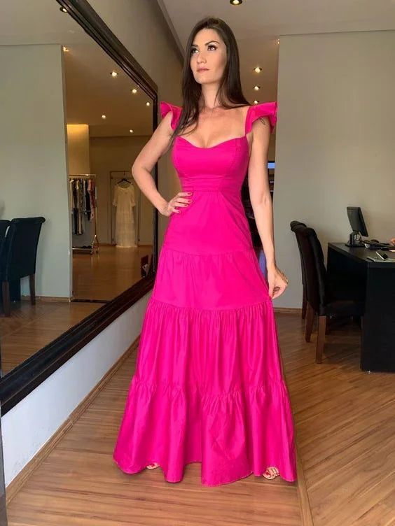 Woman modeling bright pink maxi dress in boutique, ZAPDRESS fashion style