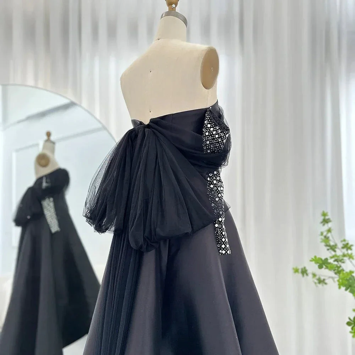 Elegant black strapless gown with tulle accents on mannequin, ZAPDRESS fashion display