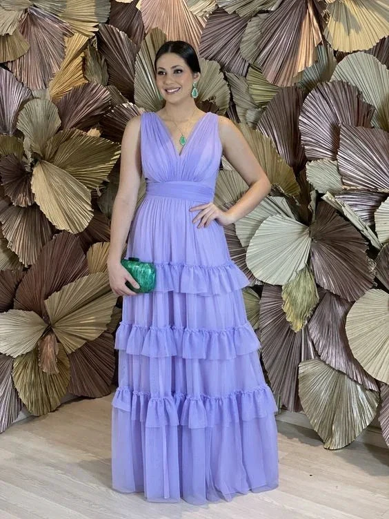 Woman in a lavender ruffled evening gown with green clutch, standing by metallic leaf wall, ZAPDRESS