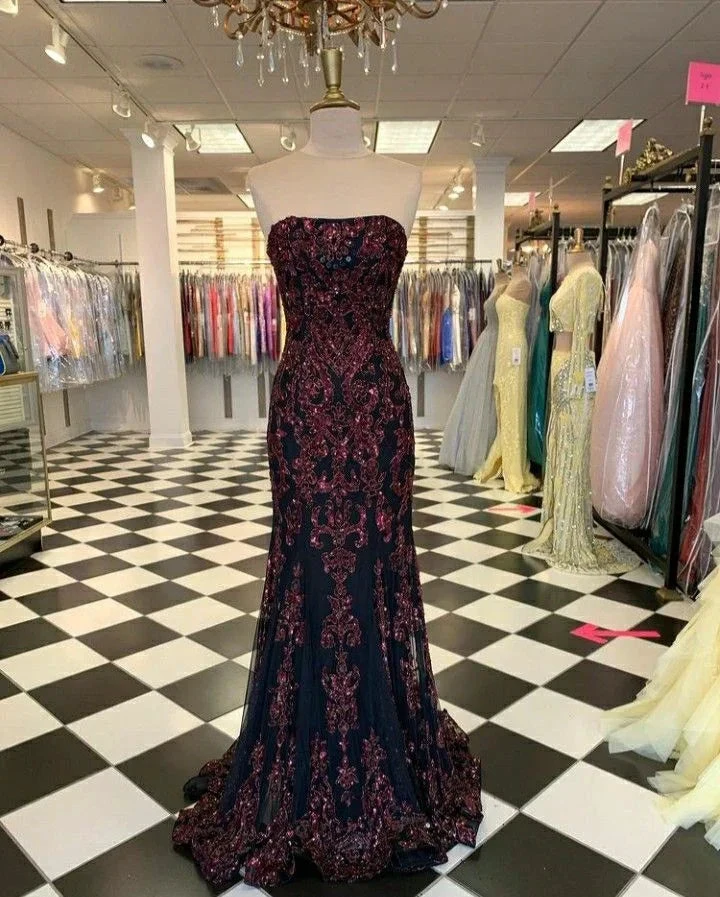 Elegant strapless black and burgundy evening gown on mannequin in ZAPDRESS formal dress store