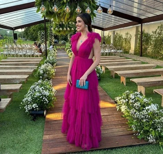 Woman in vibrant magenta evening gown holding a teal clutch at outdoor wedding venue, ZAPDRESS