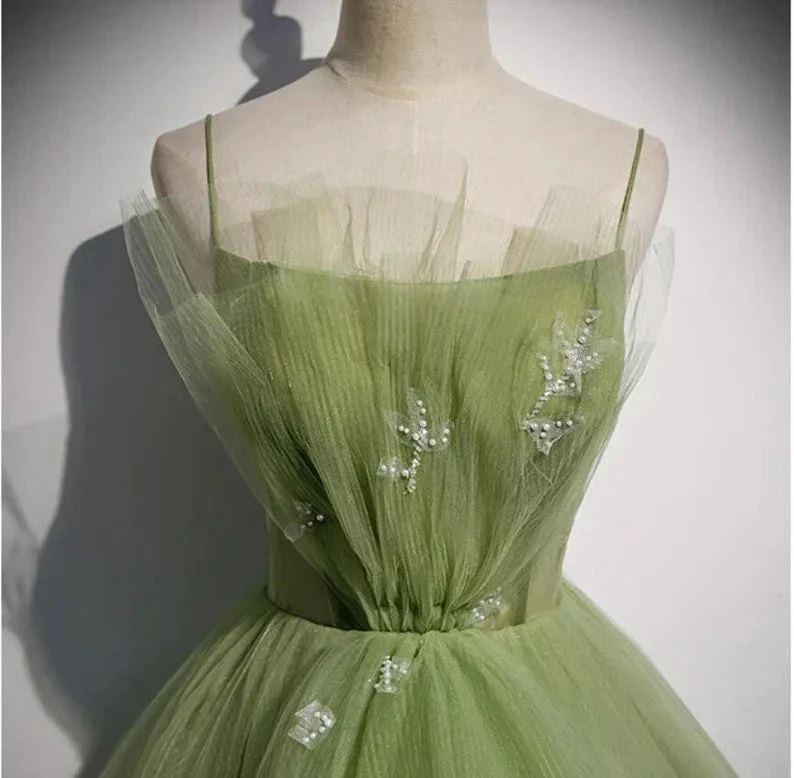 Elegant green tulle dress with delicate pearl embellishments on a mannequin, ZAPDRESS fashion
