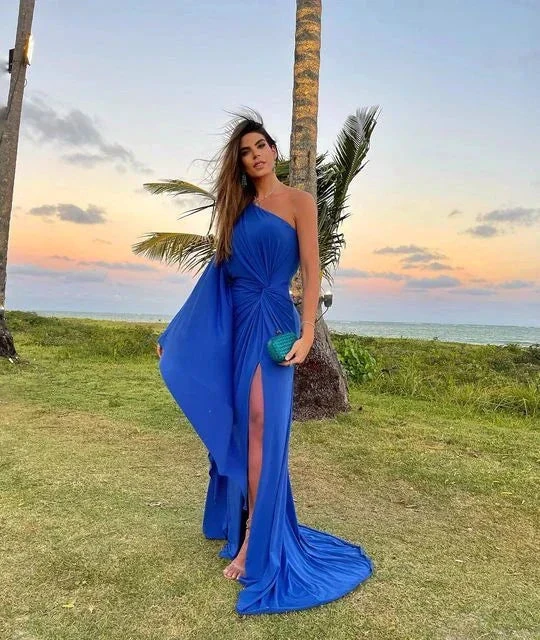 Woman in elegant blue one-shoulder evening dress outdoors at sunset, ZAPDRESS fashion style