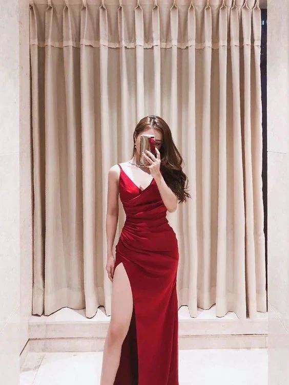 Woman posing in a red evening gown with high slit in front of beige curtains at ZAPDRESS