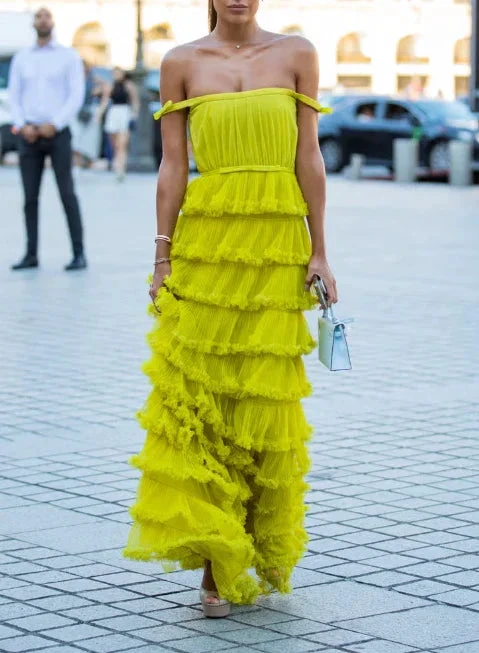 Woman in a bright yellow ruffled off-shoulder gown walking on city street, ZAPDRESS fashion