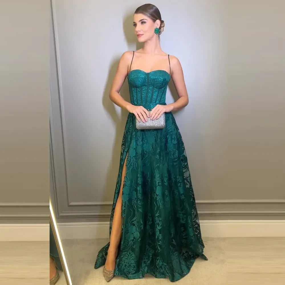 Woman in a green evening gown with floral lace, holding a silver clutch, ZAPDRESS fashion