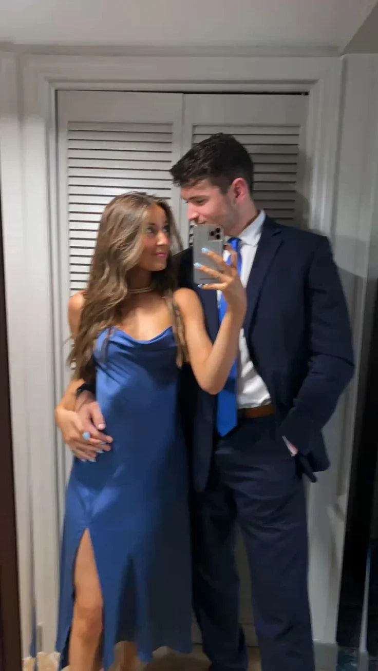Couple taking mirror selfie, woman in blue satin dress, man in suit with blue tie, ZAPDRESS style