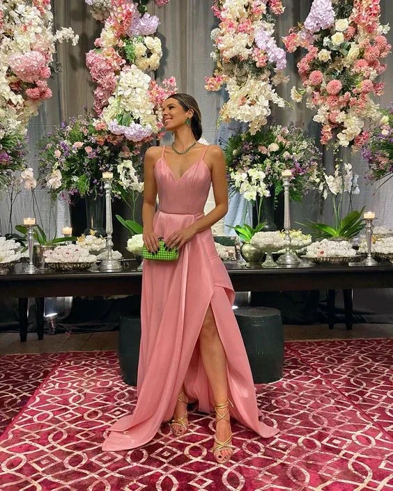 Woman in pink formal dress with green clutch at flower-decorated event, ZAPDRESS fashion