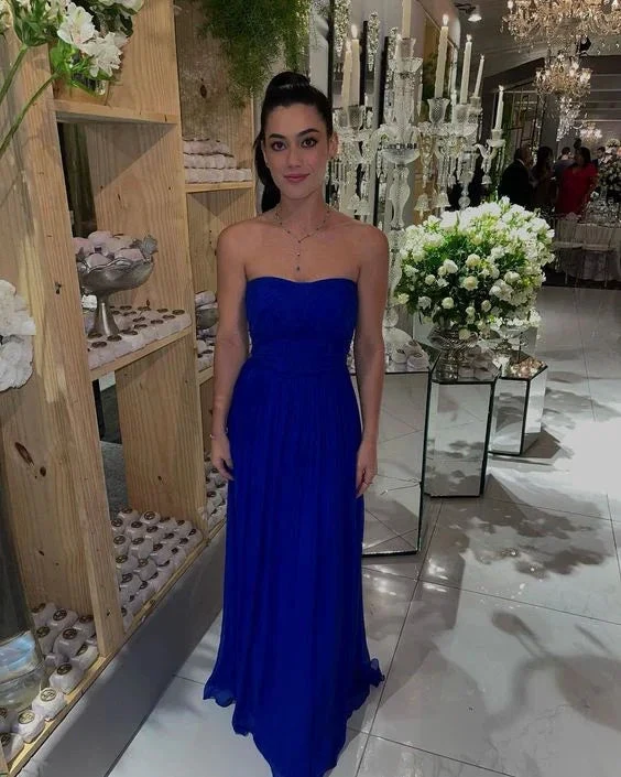 Woman in strapless royal blue evening gown at elegant event with flowers, ZAPDRESS style