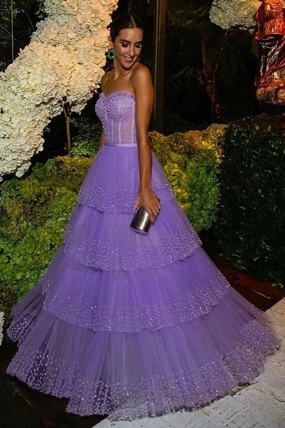 Woman in a tiered lavender tulle ball gown at an elegant event, ZAPDRESS fashion