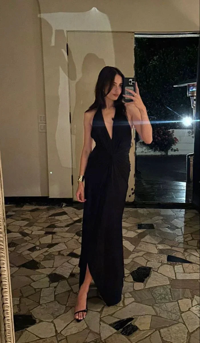 Woman in black halter dress taking mirror selfie indoors on mosaic tile floor, ZAPDRESS