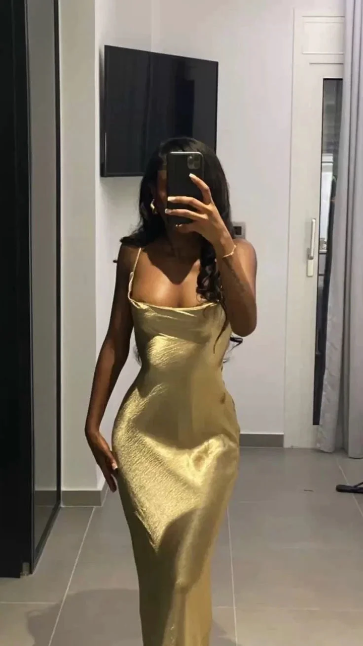 Woman in gold satin slip dress taking mirror selfie, elegant look, ZAPDRESS fashion