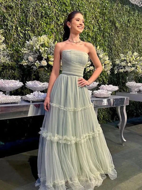 Woman in strapless pastel green evening gown at elegant event, ZAPDRESS fashion