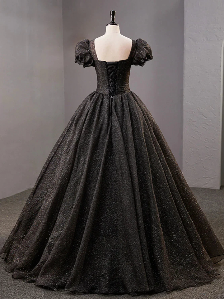 Elegant black ball gown with puff sleeves and lace-up back on mannequin at ZAPDRESS