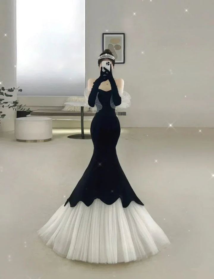 Elegant woman in a black and white mermaid dress taking mirror selfie, ZAPDRESS fashion