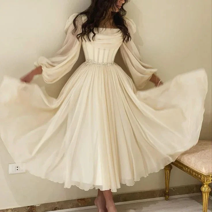 Woman wearing elegant cream long-sleeve midi dress with flowy skirt, ZAPDRESS fashion