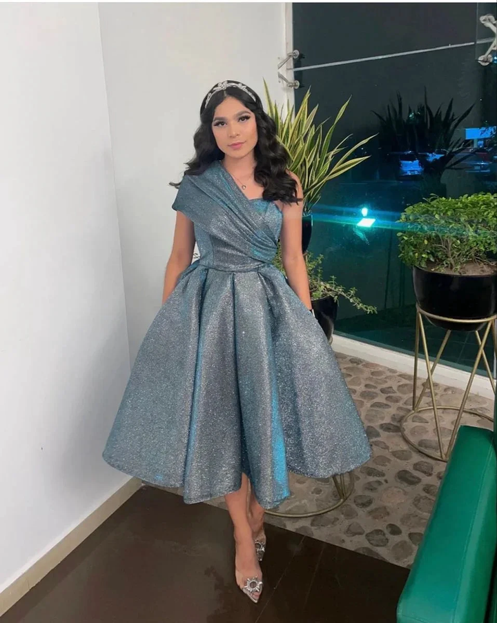 Woman in sparkly silver one-shoulder dress at indoor event, ZAPDRESS fashion style