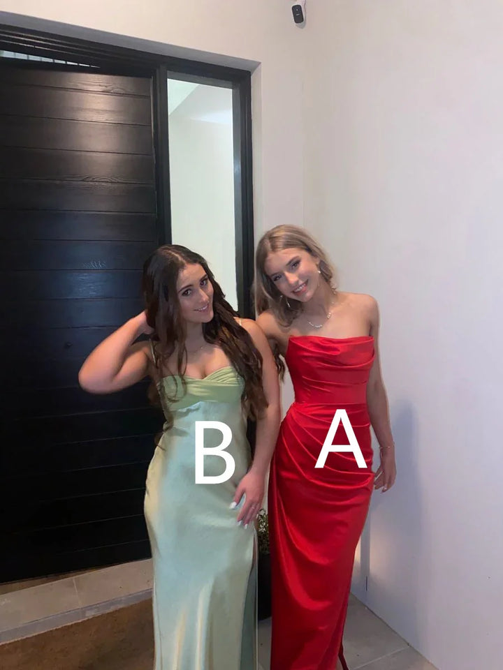Two women wearing formal gowns, one in red and one in light green, standing indoors at ZAPDRESS