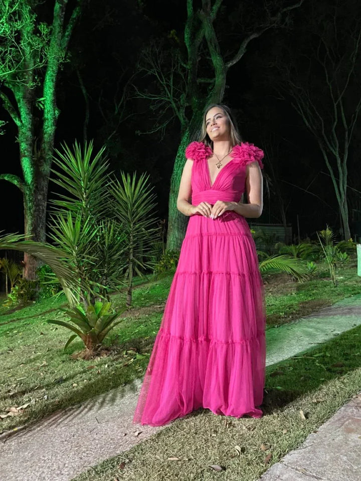 Woman in a vibrant pink tulle evening dress standing outdoors, ZAPDRESS fashion