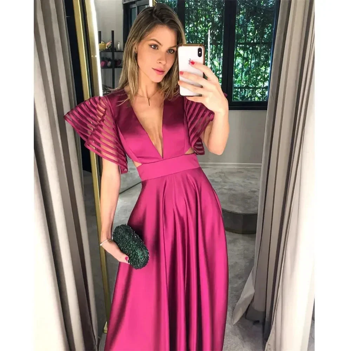 Woman taking mirror selfie in a satin magenta evening dress at ZAPDRESS boutique