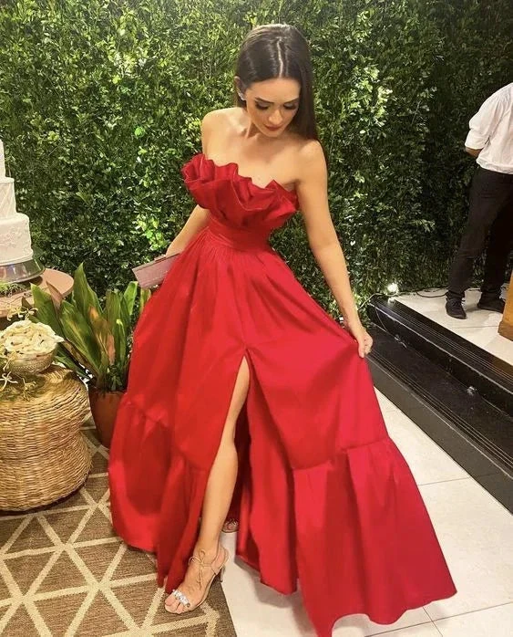 Woman in elegant red strapless evening gown with slit at ZAPDRESS event, indoor garden backdrop