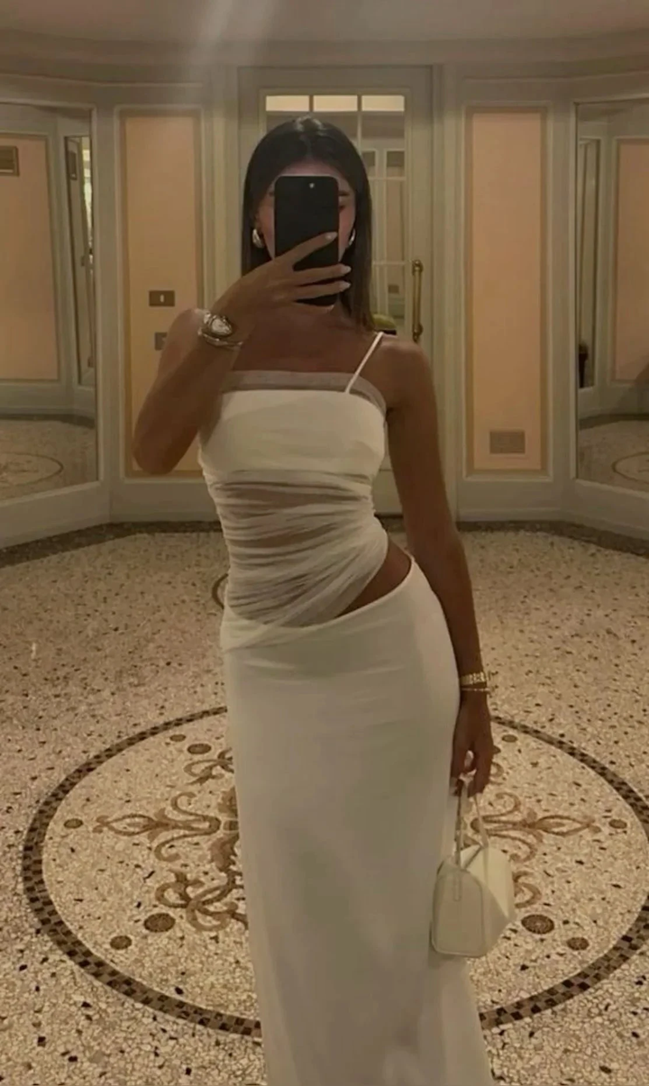 Woman in elegant white dress taking mirror selfie, luxury setting, ZAPDRESS fashion