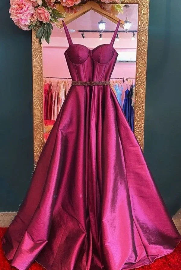 Elegant magenta evening gown with fitted bodice, displayed in ZAPDRESS boutique mirror.
